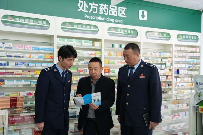 1762999643871016786.jpg 图为税务人员向企业职工讲解税收政策.jpg